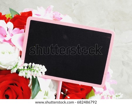 space background with bouquet of flowers and empty wooden tag