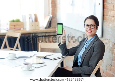 Woman showing her smartphone with online curious information