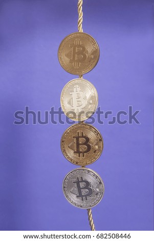 Four virtual coins bitcoins on violet background