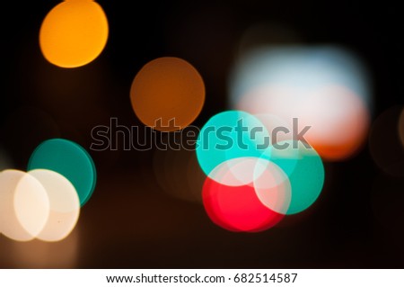 colorful bokeh of lights in city night, out of focus abstract background wallpaper
