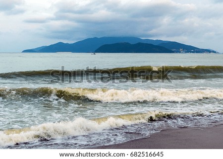 Sea landscape. Evening on the beach. Vietnam, Nha Trang. Waves in sunset time.
