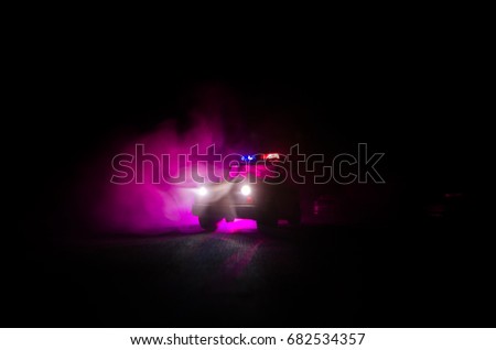 speed lighting of police car in the night on the road. Police cars on road moving with fog. Selective focus