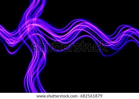 Pink and purple light painting photography, long exposure, criss cross pattern against a black background