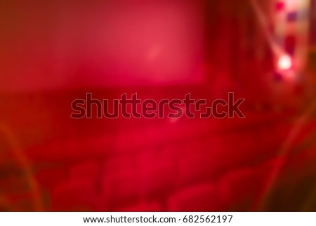 abstract background of red blurred horror inside of theater with row of chair and ghost effect
