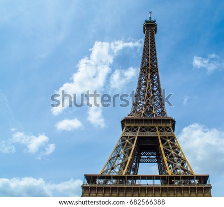 Eiffel Tower, Paris. The famous landmark of France, with a Blue Cloudy Sky on a Summer's Day.