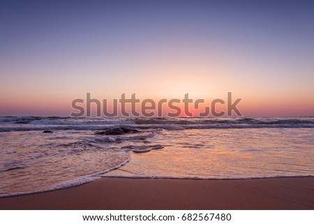 Colorful ocean beach sunrise at summer