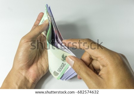 Hand counting money Royalty-Free Stock Photo #682574632