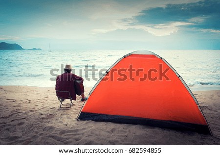 Camping tents in starry night on seaside