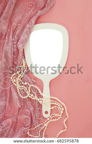 Top view image of vintage hand mirror and delicate female romantic scarf. Can be used for photography montage