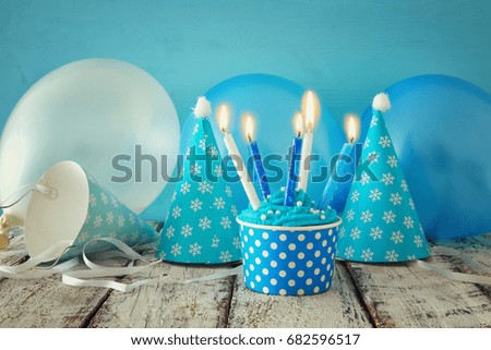 Birthday concept with cupcake and candles on wooden table