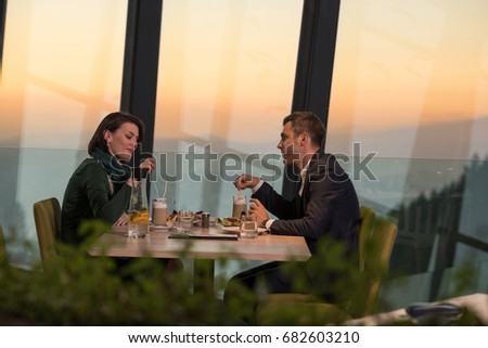 Couple celebrate Valentine's day with romantic dinner in restaurant near the window
