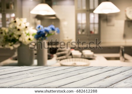 Blurred and abstract background. Empty wooden tabletop with tray and defocused modern kitchen background for display or montage your products.