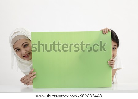 mother and daughter holding placard