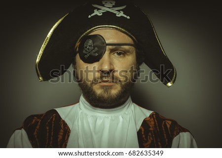 Buccaneer, Man with beard dressed like a pirate, with eye patch and steel sword