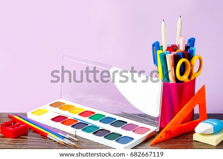 Back to school concept. School supplies on a pastel background