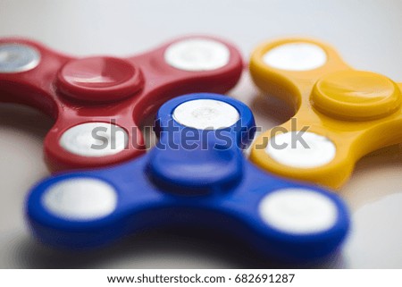 Hand Spiner. Stress relieving toy on white background. Close-up. Top view. Stock photo