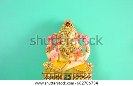 Hindu lord ganesha idol for festivals and celebrations isolated on white background. Also known as vinayagar or ganapathi. isolated on turquoise background. 
