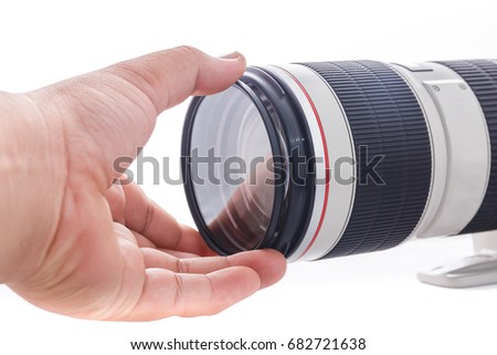 Put filter on front lens camera on white background.