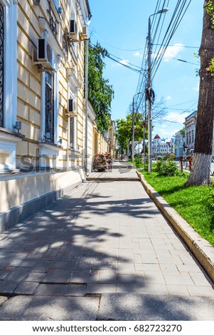 View of the city sidewalk on a summer day