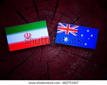 Iranian flag with Australian flag on a tree stump isolated