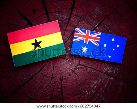 Ghanaian flag with Australian flag on a tree stump isolated