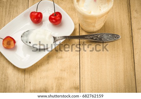 cherries on a white saucer and ice cream/cherries on a white saucer and ice cream with copy space