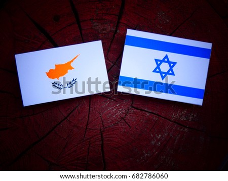 Cypriot flag with Israeli flag on a tree stump isolated