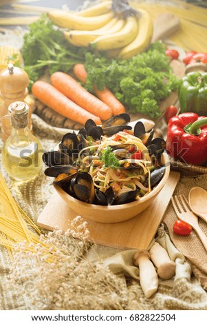 mussel and spaghetti on a deep wooden bowl. homemade food style.