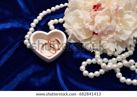 Two wedding rings for bride and groom and Peony flower.