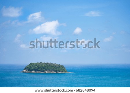 Tropical island in Phuket. Coconut palms island and sea in Andaman sea.