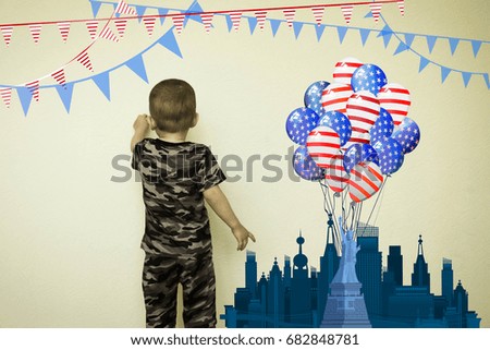 The concept of patriotic education. An American little boy draws on the wall a state of freedom. Fantasy for children. Photo illustration for your design.