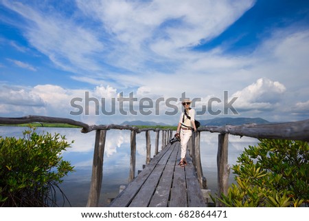 Asian Woman On Wood Bridge With Beautiful Sky Background