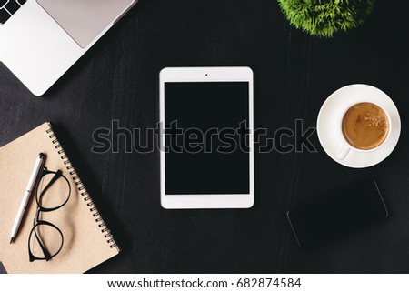 digital tablet blank screen on work desk top view