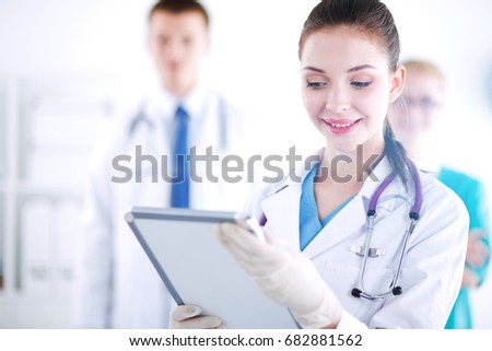 Woman doctor standing with folder at hospital. Woman doctor