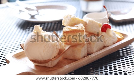 Out of focus and blur picture: ice cream and cube bread on wooden plate
