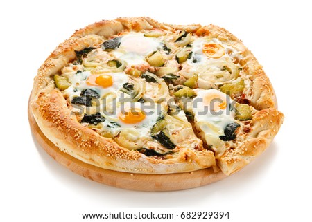 Vegetarian pizza with eggs, zucchini and onion