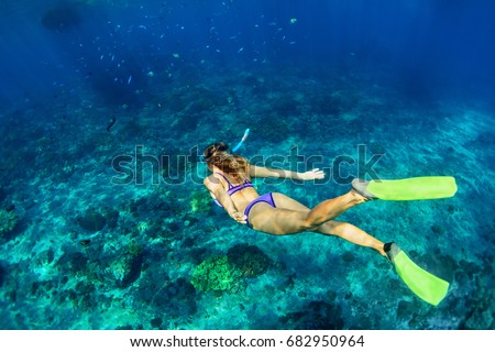 Happy family - girl in snorkeling mask dive underwater with tropical fishes in coral reef sea pool. Travel lifestyle, water sport outdoor adventure, swimming lessons on summer beach holiday with kids Royalty-Free Stock Photo #682950964