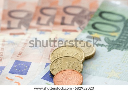 European coins on the various Euro banknotes like background.