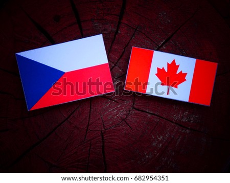 Czech flag with Canadian flag on a tree stump isolated