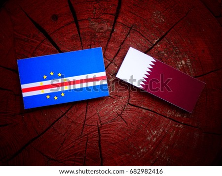 Cape Verde flag with Qatari flag on a tree stump isolated