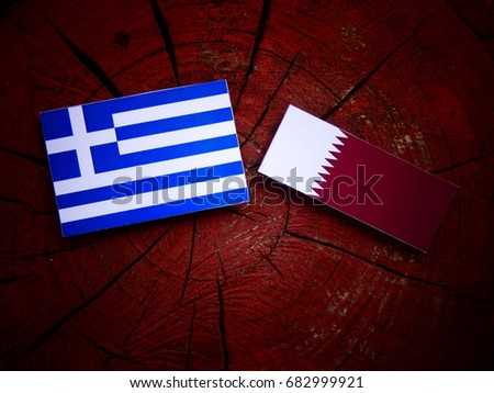 Greek flag with Qatari flag on a tree stump isolated