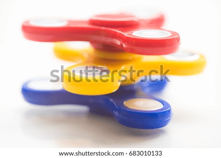 Hand Spiner. Stress relieving toy on white background. Close-up. Top view. Stock photo