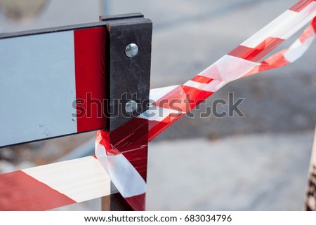 Red and white road signs, asphalt reconstruction in summer time, barrier