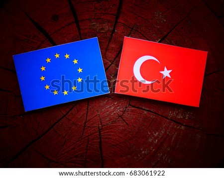 EU flag with Turkish flag on a tree stump isolated