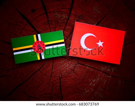 Dominica flag with Turkish flag on a tree stump isolated
