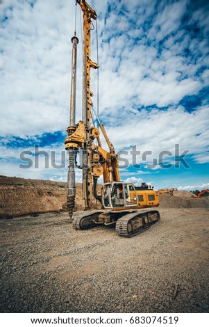Details of heavy duty machinery on construction site. Detail of highway building with rotary drilling machine  Royalty-Free Stock Photo #683074519