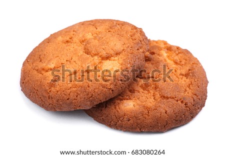 A close-up picture of a couple of crunchy cookies isolated over the white background. Yummy light brown biscuits for a healthful snack. A delicious homemade traditional pastry.  
