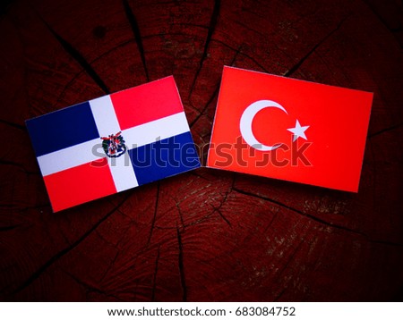 Dominican Republic flag with Turkish flag on a tree stump isolated