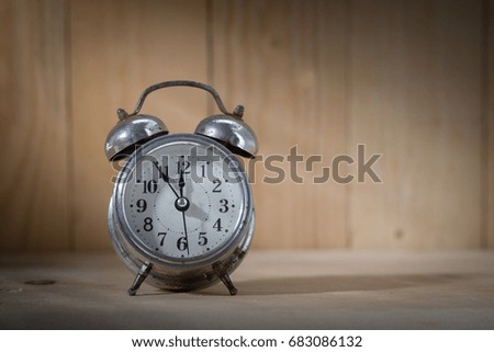 Vintage background with retro alarm clock on table