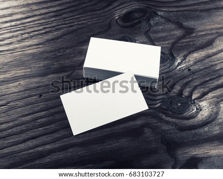 Photo of blank white business cards on wood background. For design presentations and portfolios. Mock-up for branding identity. Top view.